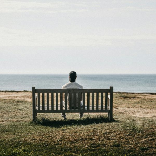 Man meditating outdoors during sunrise, symbolizing mental clarity.